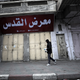 A man walks next to closed shops during a strike in Gaza City.